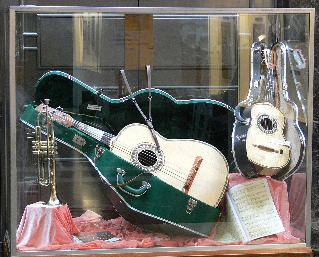 Mariachi string instruments and a trumpet on display.