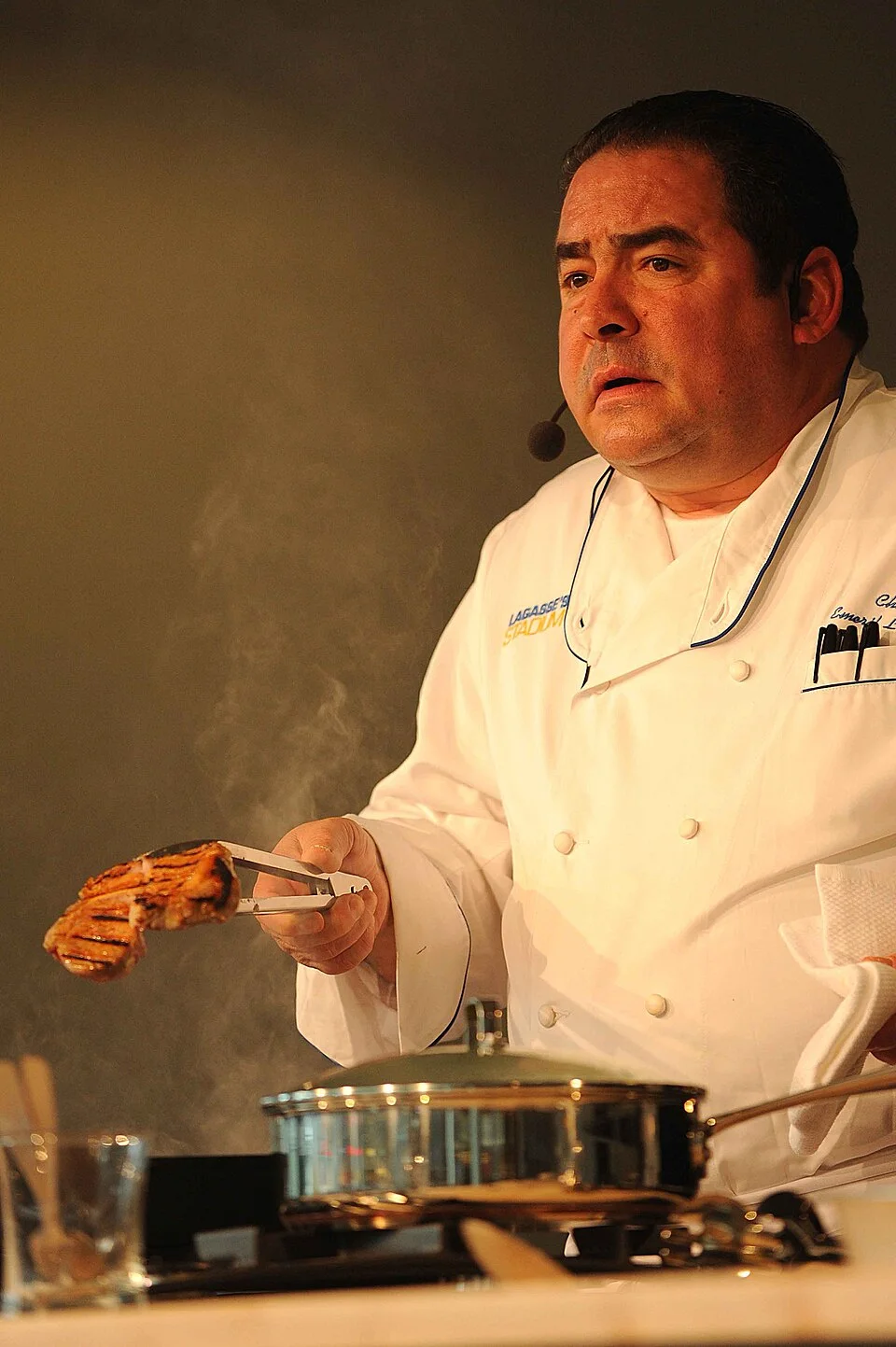 Emeril Lagasse in a white chef coat demonstrating cooking in 2010.